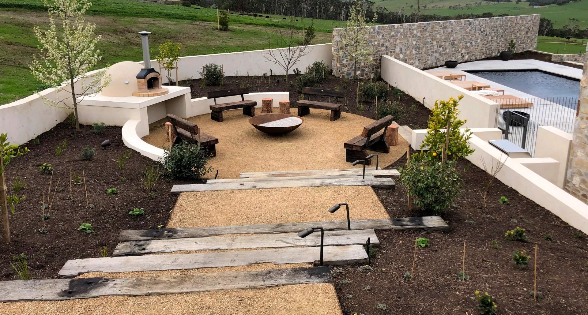 Australian hardwood dining table in a native garden at dusk